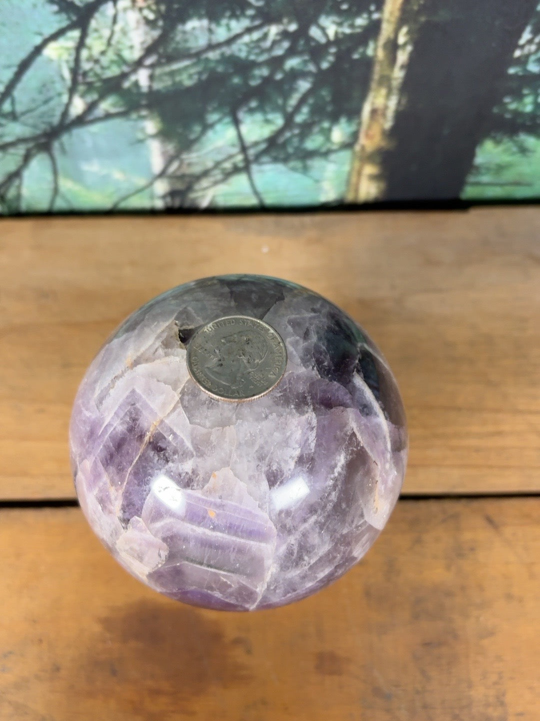 Large chevron amethyst sphere shown with quarter for scale