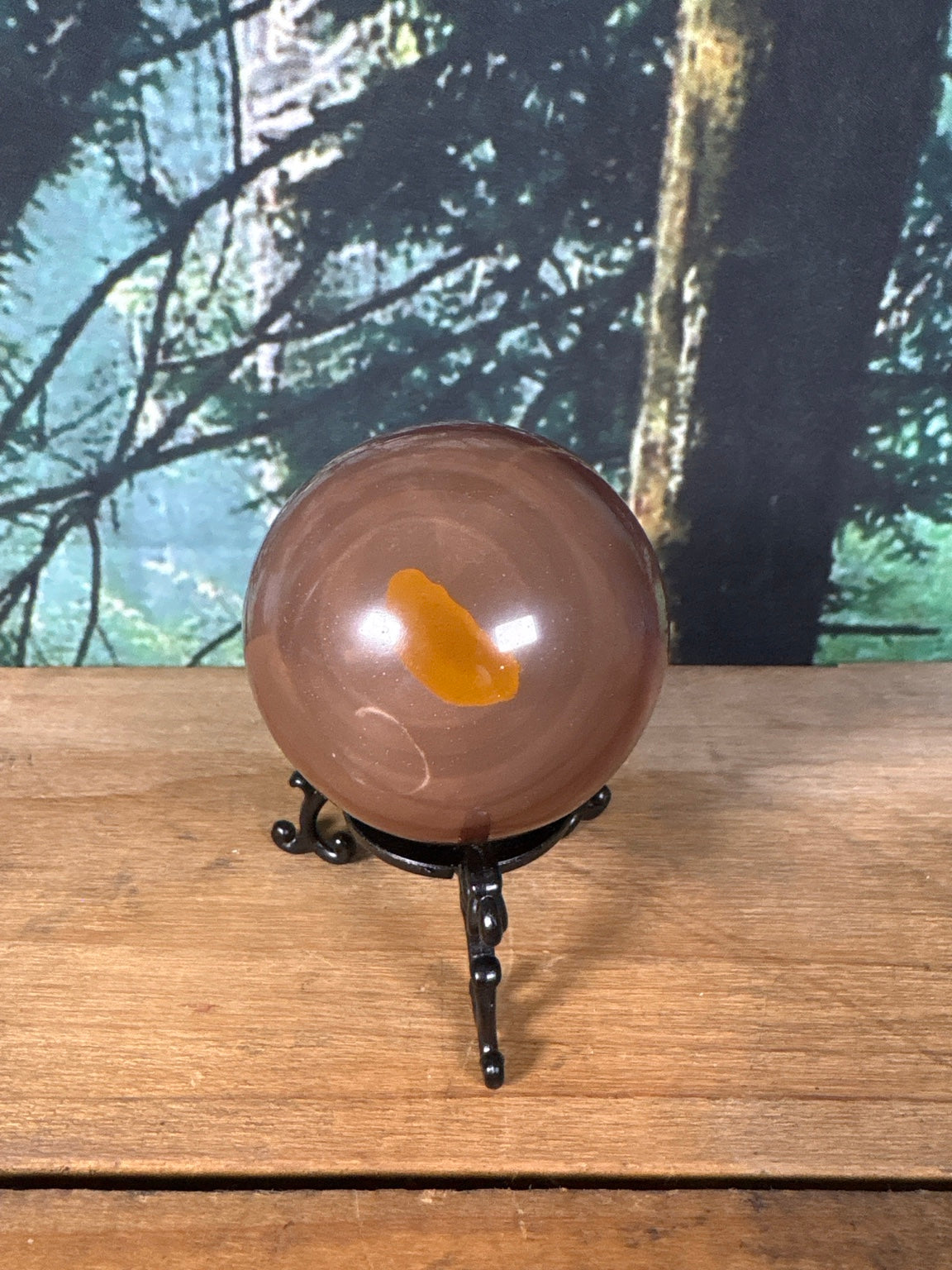 Chocolate Calcite sphere with caramel mineral window front view