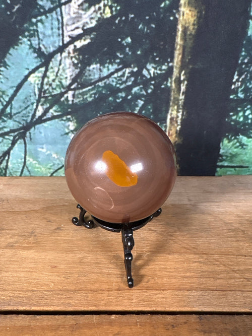 Chocolate Calcite sphere with caramel mineral window front view