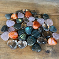 Assorted polished gemstone heart bags with rose quartz labradorite smoky quartz and carnelian