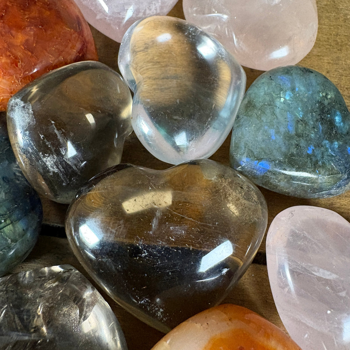 Close view of clear quartz smoky quartz labradorite and rose quartz hearts