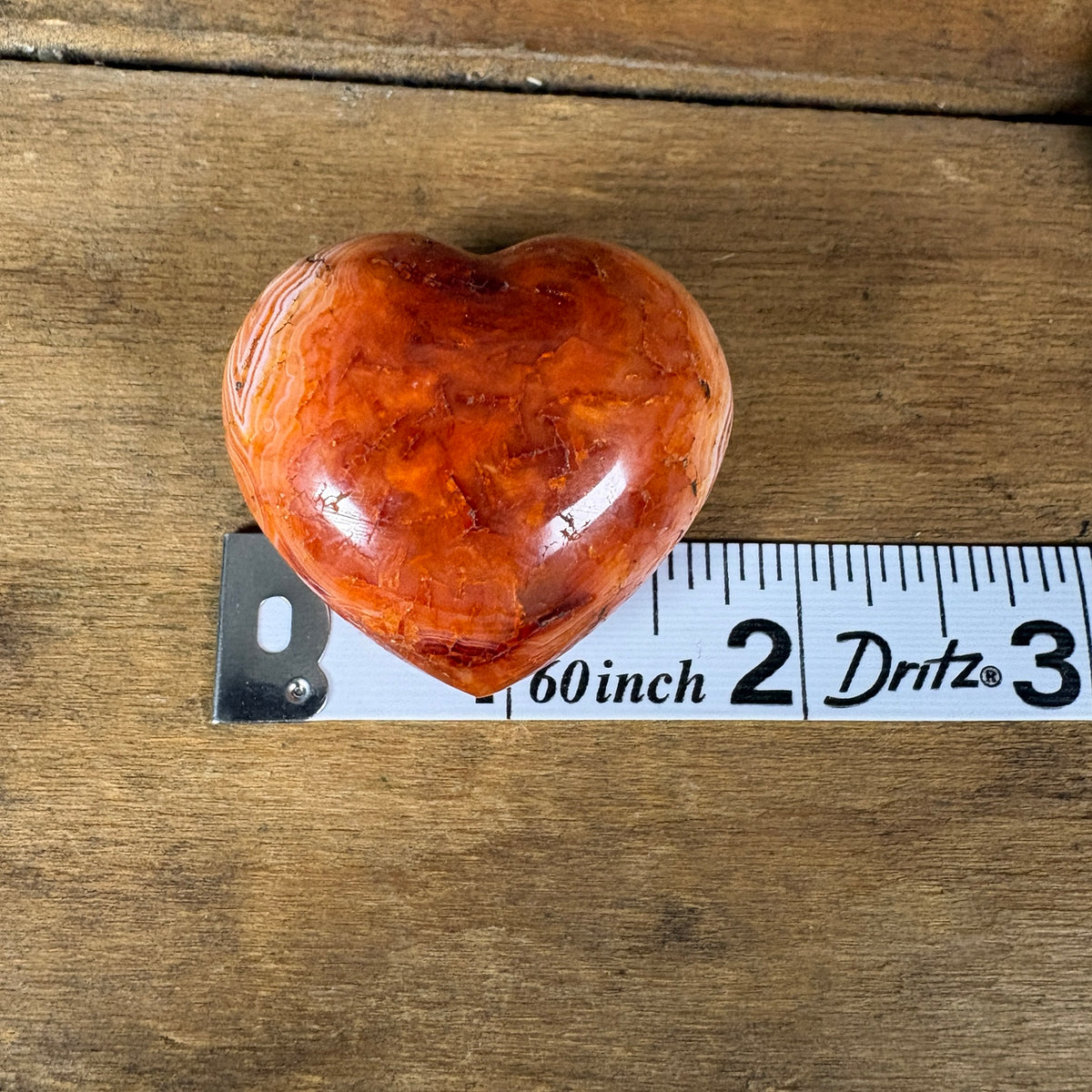 Carnelian banded agate heart approximately one and a half inches wide